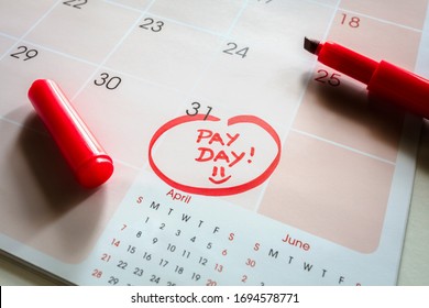 Payday end of month date on calendar with red marker and circled salary day