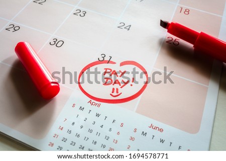Payday end of month date on calendar with red marker and circled salary day
