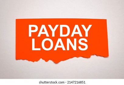 PAYDAY LOANS is written on a white sheet of paper. High quality photo