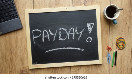 Payday Written On A Chalkboard At The Office