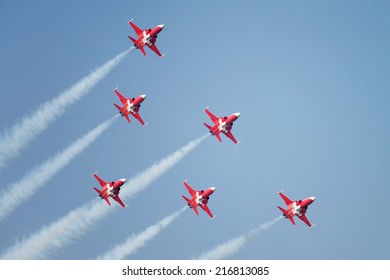 PAYERNE, SWITZERLAND - SEPTEMBER 6: Flight of Patrouille Suisse aerobatic team in close formation on AIR14 airshow in Payerne, Switzerland on September 6, 2014