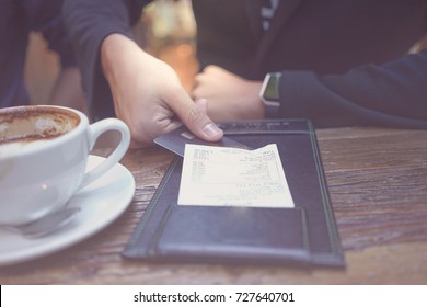 Paying The Bill. A Businessman Is Paying The Bill By Using His Credit Card At The Restaurant.