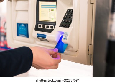 Paying For Gas. Mans Hand Inserting Credit Card At ATM At Gas Pump