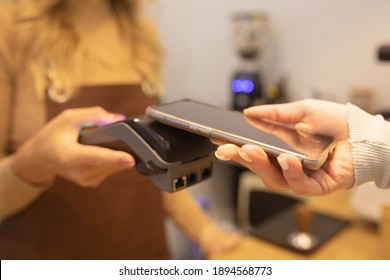 Paying with Mobile Phone. Costumer scanning phone to pay.