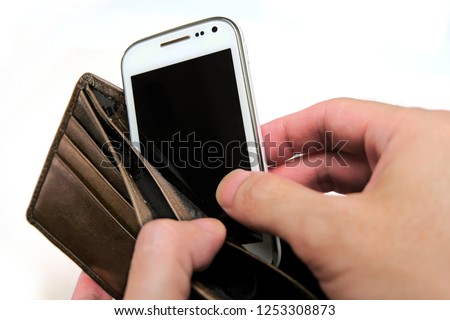 Paying with your phone - hand taking out smartphone from an empty wallet. Concept for digital wallet payment, cashless payment via mobile app, electronic shopping (eshopping) or modern payment method.