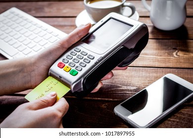 Payment By Card In Cafe With Terminal And Keyboard On Wooden Bac