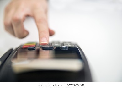 Payment Card In A Bank Terminal. The Concept Of Of Electronic Payment. Terminal Cashless Payment, Credit Card.hand Pin Code On Pin Pad Of Card Machine Or Pos Terminal Good Photo