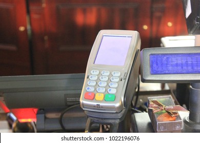 Payment Machine for Bank Credit Cards in Retail Store Desk Close Up. Small Payment Terminal at Cashier Station Checkout Lane at the Grocery Shop with Empty Copy Space.