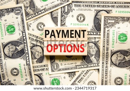 Payment options symbol. Concept words Payment options on beautiful wooden block. Dollar bills. Beautiful background from dollar bills. Business payment options concept. Copy space.