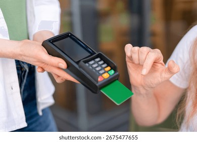 Payment process at a cafe with a card reader during a busy afternoon