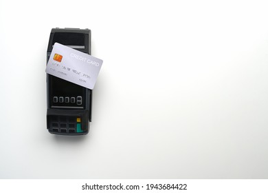 Payment Terminal And Credit Card Isolated On White Background. Copy Space For Products Display Montage.