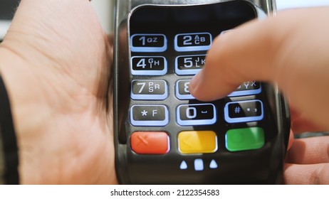 Payment Terminal. A Man Enters A PIN Code. Close Up Of A Hand On A Credit Card Pin Pad At A Retail Store.