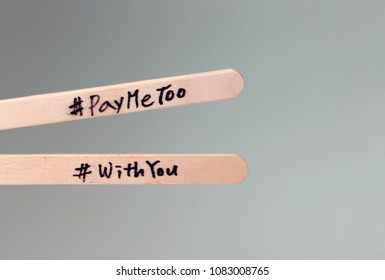 #PayMeToo As A New Campaign To Close The Wage Gap Between Men And Women. Wooden Stick And Hash Tag.