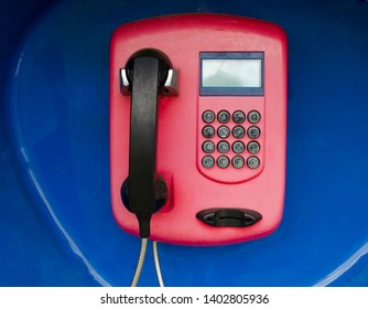 Payphone On Blue Background. Phone With Braille Table Buttons.