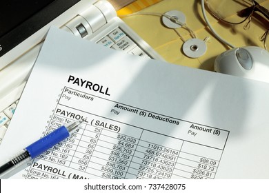 Payroll Spreadsheet With Computer Monitor And Mouse