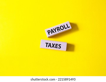 Payroll Taxes Symbol. Concept Word Payroll Taxes On Wooden Blocks. Beautiful Yellow Background. Business And Payroll Taxes Concept. Copy Space