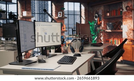 PC in empty IT startup office displaying programming languages used for building applications. Computer screen in software development agency showing code, trucking right shot