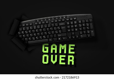 PC keyboard with words Game Over on black background