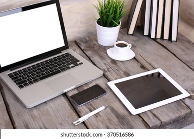 PC Laptop, Tablet And Phone On Wooden Table