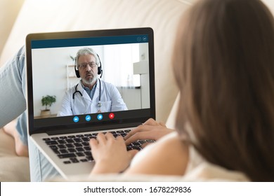 Pc monitor view over girl shoulder, old doctor wear uniform headset give consultation to client via internet about epidemic outbreak of corona virus ncov, distant communication and protection concept