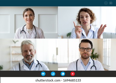 Pc screen webcam view, head shot portrait four diverse medical workers in white coats take part in distant talk, engaged in group video call. Videoconferencing, concilium remote communication concept - Powered by Shutterstock