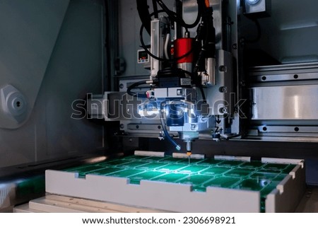 PCB separator at factory, process of separation of printed circuit boards. Automated technology, industrial, robotic, electronic, production, manufacturing concept