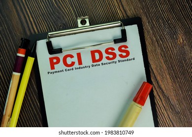 PCI DSS - Payment Card Industry Data Security Standard write on a paperwork isolated on Wooden Table.