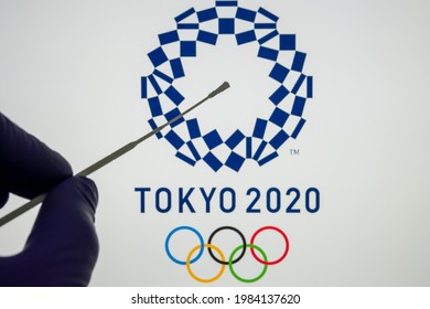 PCR Test Swab In Front And Blurred Tokyo 2020 Logo On The Blurred Background. Concept For Tokyo COVID Olympic Games In 2021. Stafford, United Kingdom, June 1, 2021.