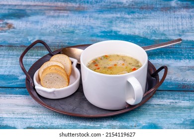 Pea Soup Puree In A Large White Cup On A Vintage Tray