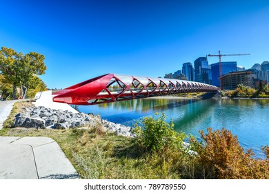 Peace Bridge with Bow River and part of the Calgary downtown in a sunny autumn day.