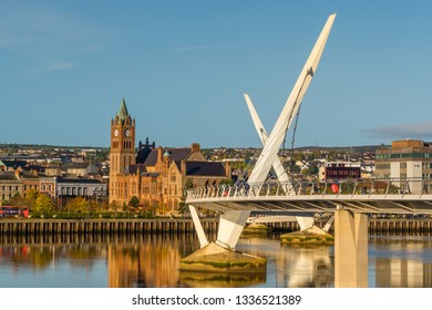 Peace bridge and guildhall in Derry Londonderry Northern Ireland with warm sunny sky