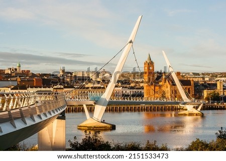 The Peace Bridge over the River Foyle and Guildhall in Derry City
