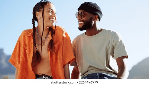 Peace, love and couple in the city to relax, smile and be happy together in summer. Portrait of an urban and interracial man and woman with hand sign for communication and comedy against a blue sky - Powered by Shutterstock