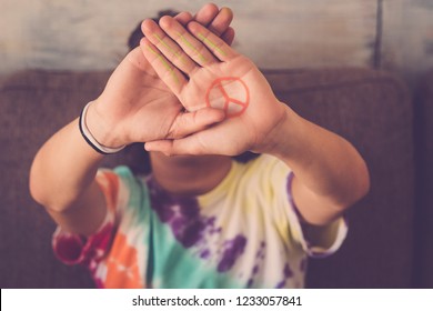 peace no war symbol painted on hand of young boy - message for the future generations - make love be friends together forever - stop fight conceptual image