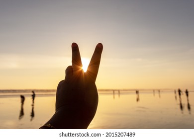 Peace sign at sunset with copy space
