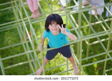 Peace Sign.Child With Friends On Outdoor Jungle Gym.Children Playing Outside.Boy Exercising.Active Kid Summer Activity.Preschooler Climbing Game.Childhood Traditional Activity.Fun Enjoyment For Kids.