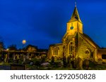 Peace and solitude of a medieval church and cemetery at night in Sanderstead, Croydon, UK in winter