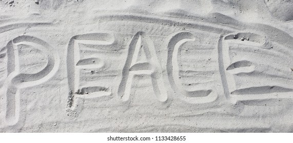 Peace written on the beach in the sand - Shutterstock ID 1133428655