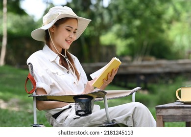 Peaceful Asian Woman Reading Book During Camping Alone Near Creek On Summer Holiday