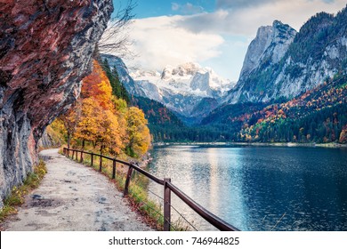 Peaceful autumn scene of Vorderer ( Gosausee ) lake with Dachstein glacieron background. Picturesque morning view of Austrian Alps, Upper Austria, Europe. Traveling concept background.