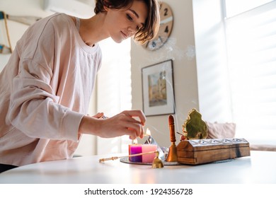 Peaceful Beautiful Girl Lighting Candles At Home Shrine Indoors