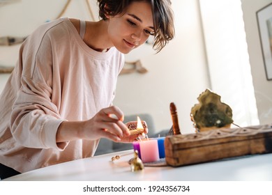 Peaceful Beautiful Girl Lighting Candles At Home Shrine Indoors