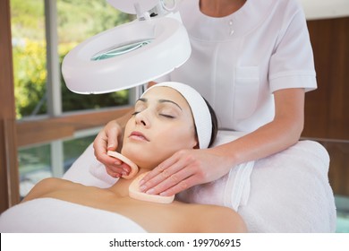 Peaceful Brunette Getting Facial From Beauty Therapist In The Health Spa