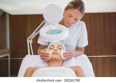 Peaceful Brunette Getting Facial From Beauty Therapist In The Health Spa