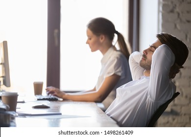 Peaceful businessman relaxing in comfortable office chair after finished work in office, sitting leaning back with hands behind head, daydreaming with closed eyes, enjoying break, no stress