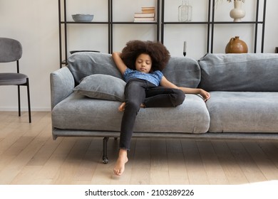 Peaceful calm cute African girl kid with curly hair resting on comfortable couch in living room, sleeping. Tired asleep child drowsing at daytime, taking nap, relaxing on sofa at home. - Powered by Shutterstock