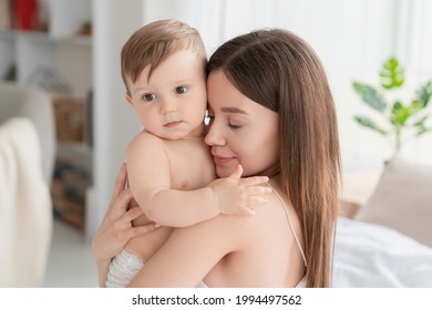 Peaceful caucasian mother holding hugging embracing small child kid with love. Nanny childminder taking care of a toddler newborn baby. Motherhood and protection concept