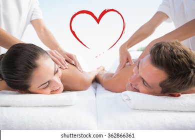 Peaceful Couple Enjoying Couples Massage Poolside Against Heart