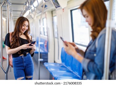 Peaceful Ethnic Female Leaning On Handrail And Messaging On Mobile Phone While Riding Modern Train, Concept For City Life Of Modern People.