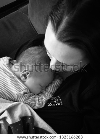Peaceful image of newborn cuddling with his mother on the first day home from the hospital. Excellent for Mother's Day use Stock photo © 